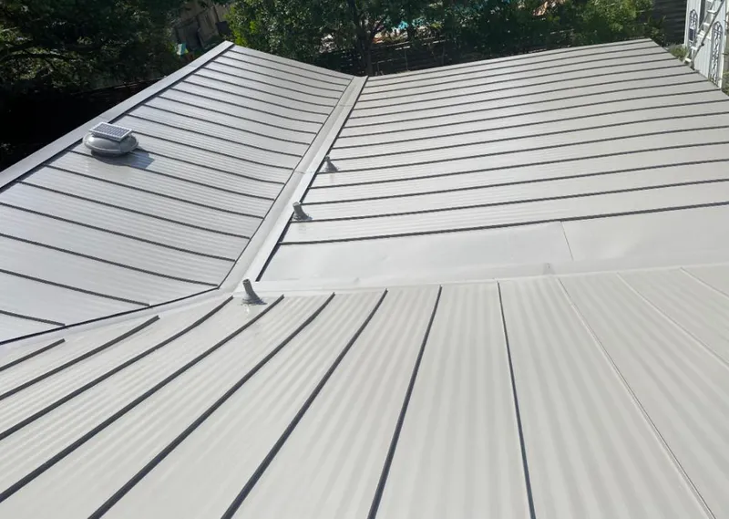 Solar attic fan installed on a metal roof for Roof Ventilation in Mercer Island